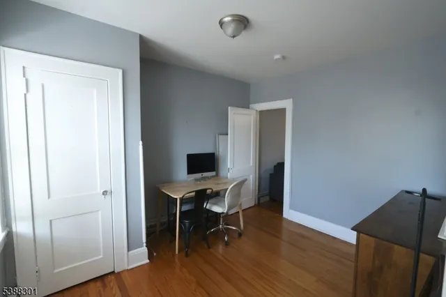 a view of a workspace with furniture and wooden floor
