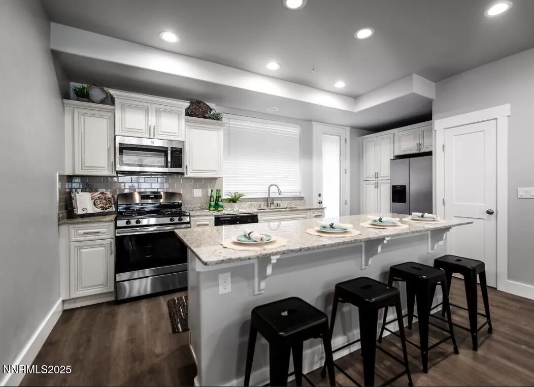 a kitchen with appliances a sink cabinets and a counter top space