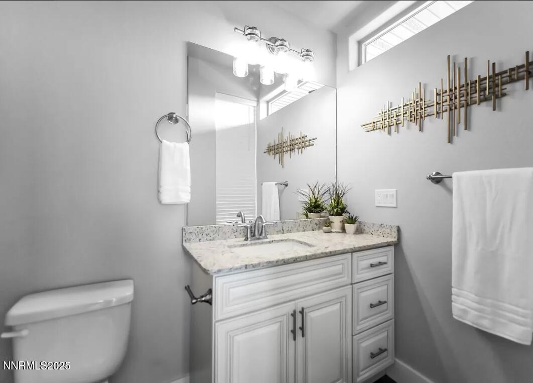 730 Bluffs Court, Unit 103 Reno, NV 89523 - Photo 5 of 6 a bathroom with a sink a toilet and mirror