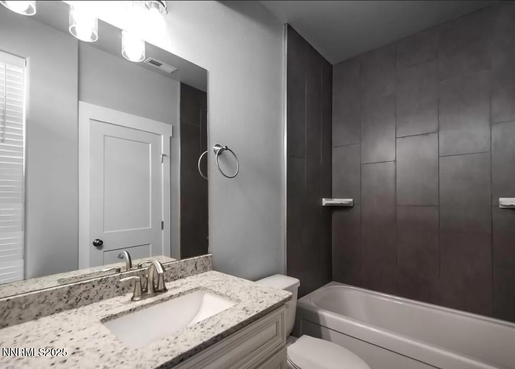 730 Bluffs Court, Unit 103 Reno, NV 89523 - Photo 6 of 6 a bathroom with a granite countertop sink toilet and shower