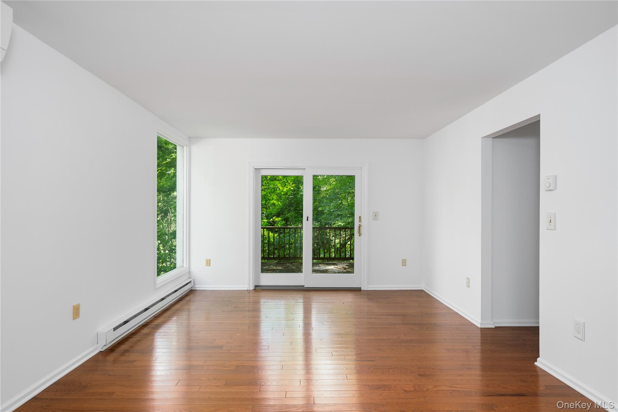 41 Chapman Road Garrison, NY 10524 - Photo 5 of 22 a view of an empty room with wooden floor and a window