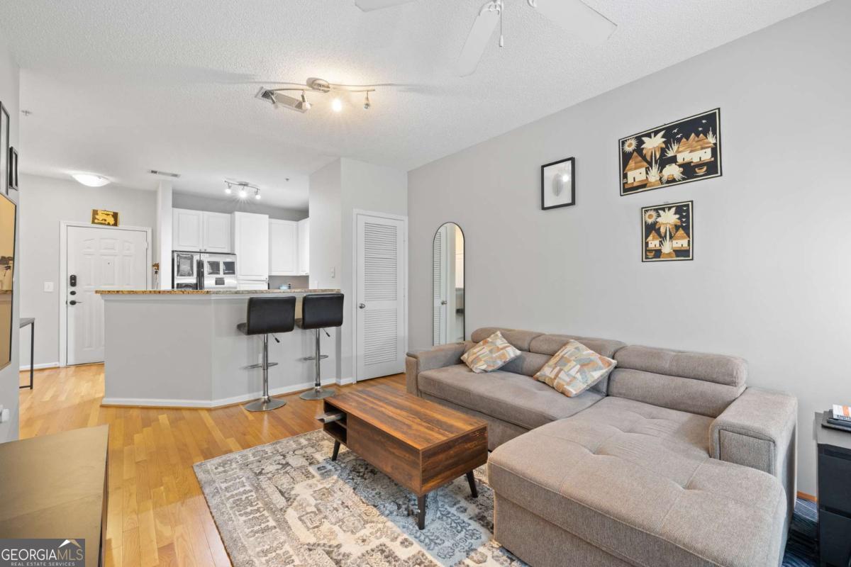 10 Perimeter Summit Boulevard Brookhaven, GA 30319 - Photo 14 of 20 a living room with furniture and kitchen view