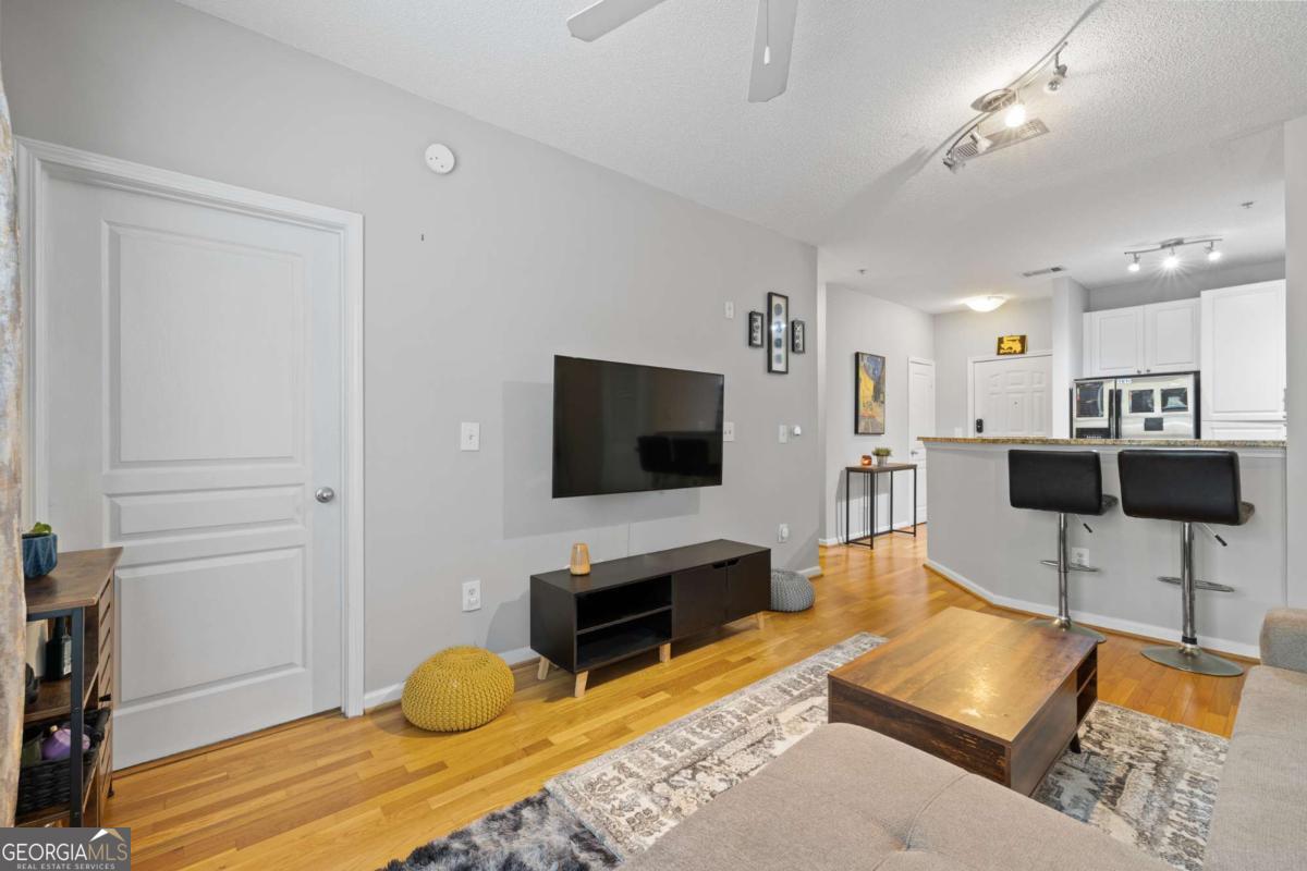 10 Perimeter Summit Boulevard Brookhaven, GA 30319 - Photo 15 of 20 a living room with furniture and a flat screen tv