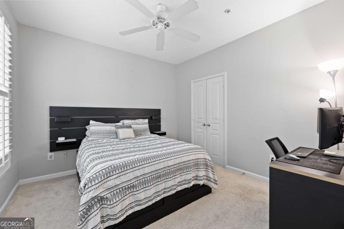 10 Perimeter Summit Boulevard Brookhaven, GA 30319 - Photo 16 of 20 a bedroom with a bed and a chandelier