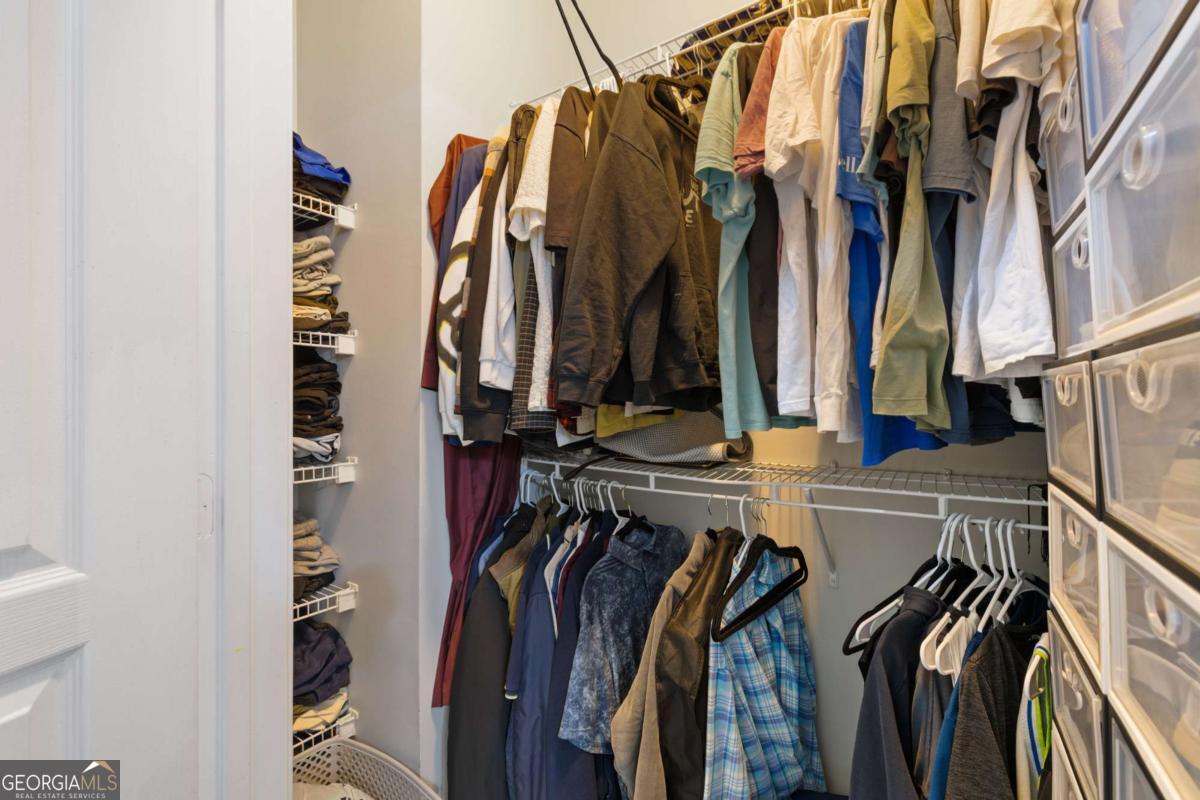 10 Perimeter Summit Boulevard Brookhaven, GA 30319 - Photo 18 of 20 a view of walk in closet with clothes and shoes