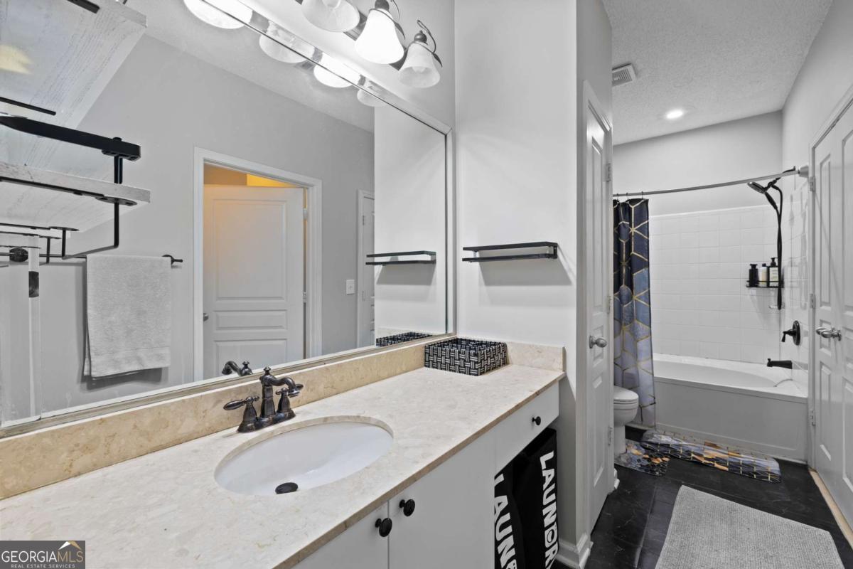10 Perimeter Summit Boulevard Brookhaven, GA 30319 - Photo 20 of 20 a bathroom with a tub sink vanity granite and shower