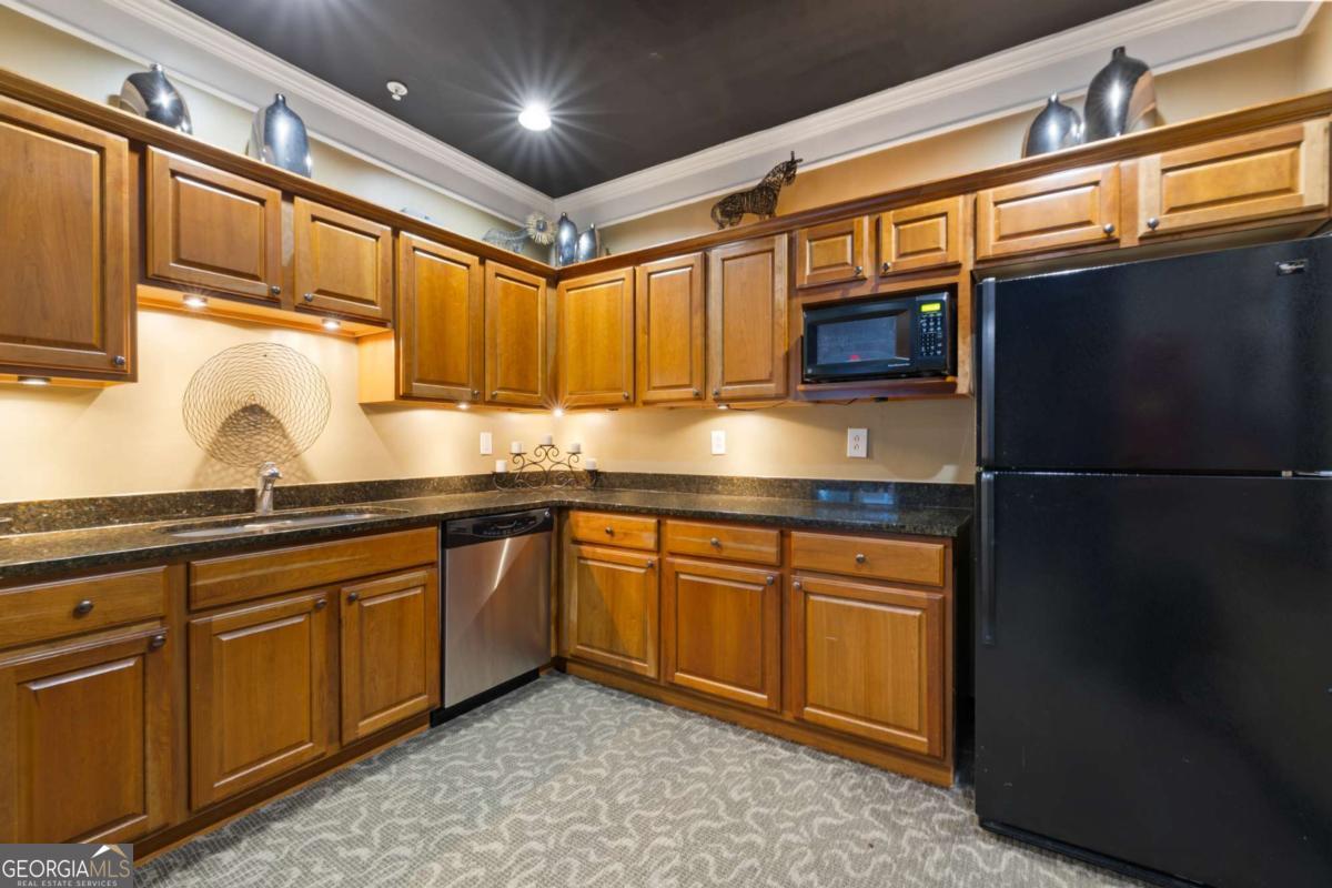 10 Perimeter Summit Boulevard Brookhaven, GA 30319 - Photo 3 of 20 a kitchen with granite countertop stainless steel appliances and wooden cabinets