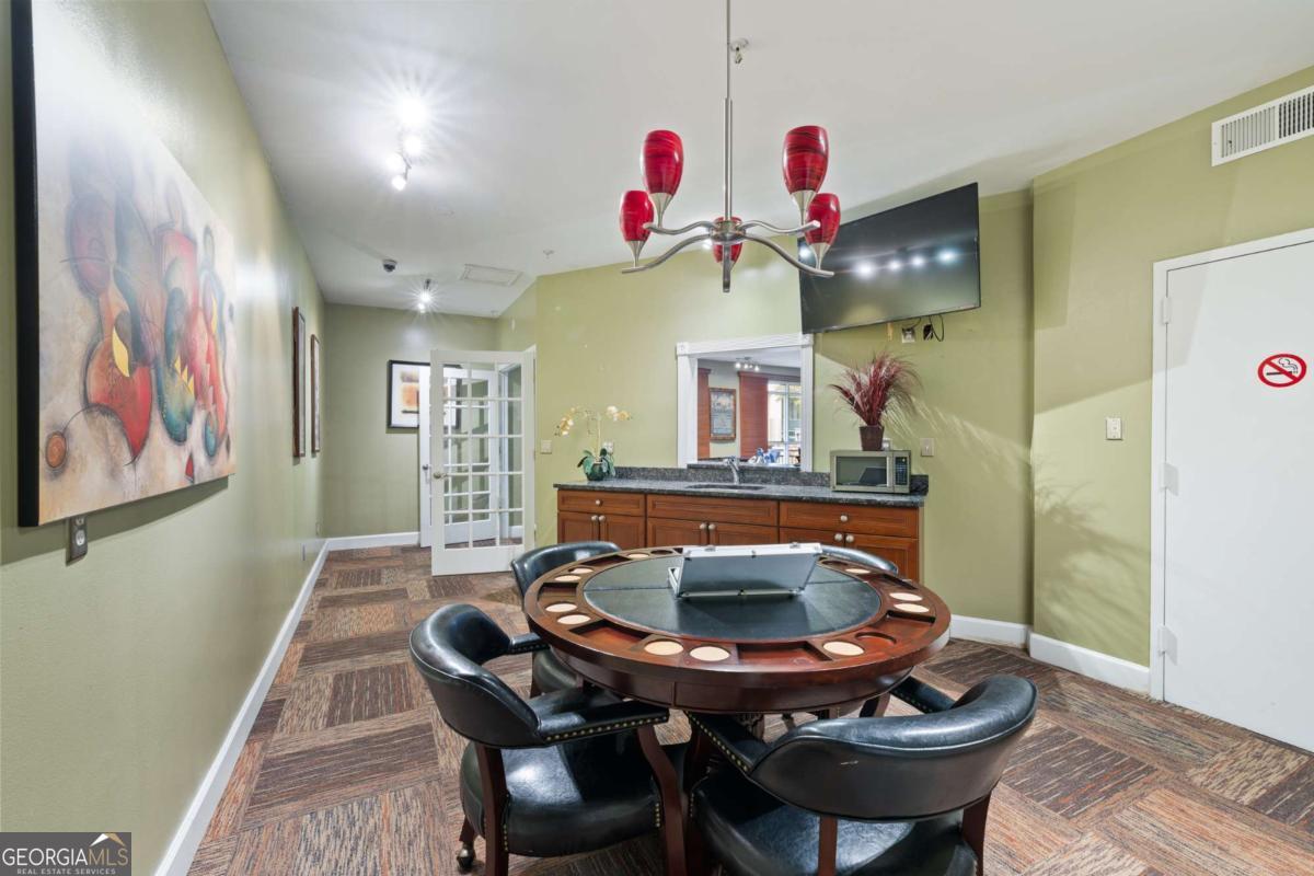 10 Perimeter Summit Boulevard Brookhaven, GA 30319 - Photo 4 of 20 a view of a dining room with furniture and wooden floor