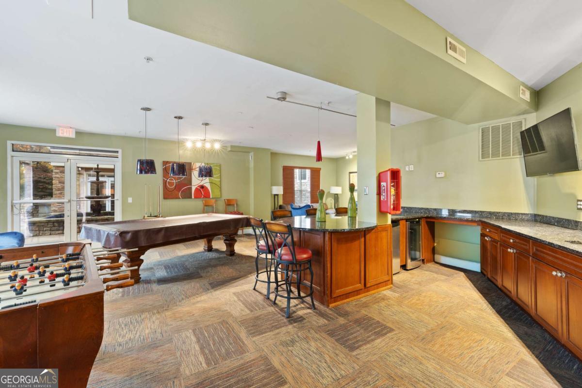 10 Perimeter Summit Boulevard Brookhaven, GA 30319 - Photo 6 of 20 a living room with furniture a dining table and chairs