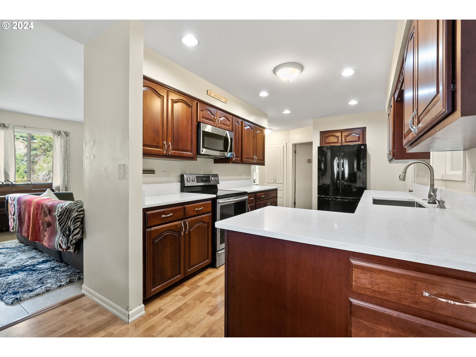 17086 South Gronlund Road Oregon City, OR 97045 - Photo 6 of 34 a kitchen with stainless steel appliances granite countertop a sink refrigerator stove and microwave