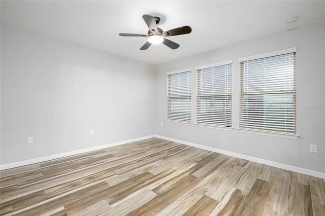 a view of a livingroom with a ceiling fan and window