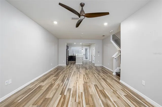 a view of a living room with a ceiling fan
