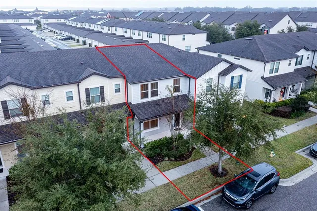 an aerial view of a house with garden space and street view