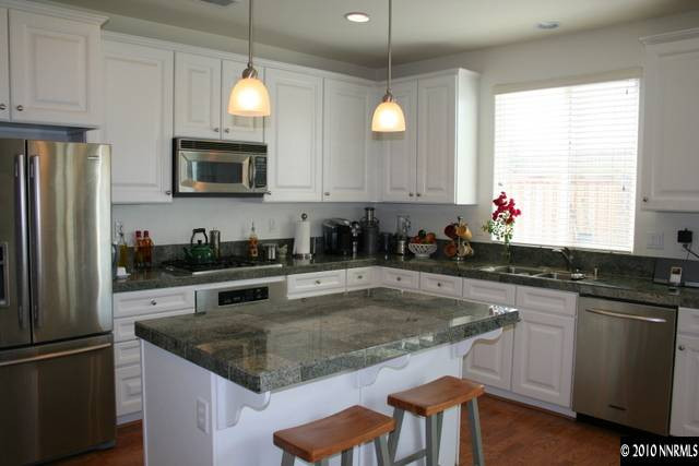 410 Stradella Court Reno, NV 89521 - Photo 2 of 9 a kitchen with stainless steel appliances granite countertop a sink a stove a refrigerator cabinets and a window