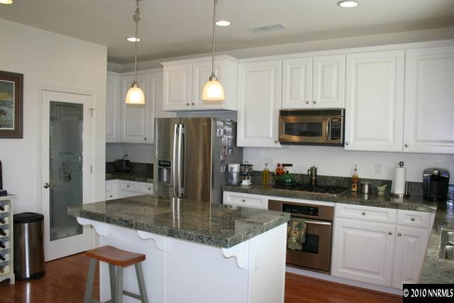 410 Stradella Court Reno, NV 89521 - Photo 3 of 9 a kitchen with stainless steel appliances granite countertop a sink a stove and cabinets