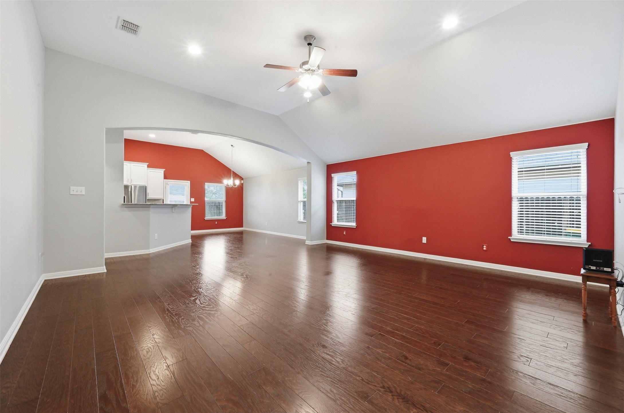 13116 Alans Way Manchaca, TX 78652 - Photo 5 of 25 Spacious interior featuring wood-finish flooring, vaulted ceilings, and an arched entryway