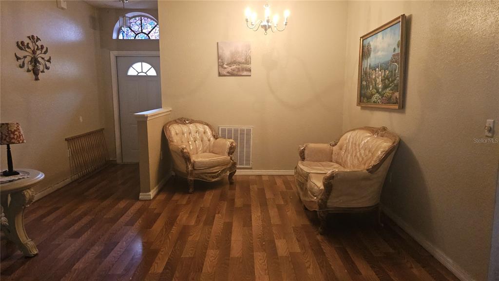 871 Reflections Loop East Winter Haven, FL 33884 - Photo 3 of 9 a living room with furniture and a wooden floor