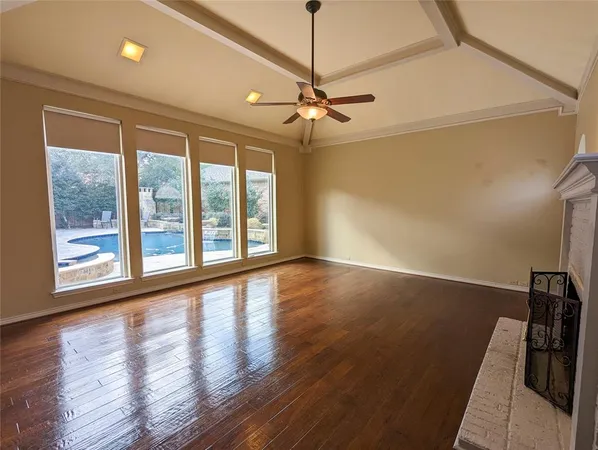 a view of room with window and wooden floor