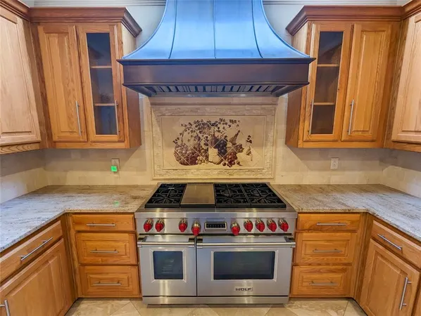 a kitchen with stainless steel appliances granite countertop a stove and a microwave