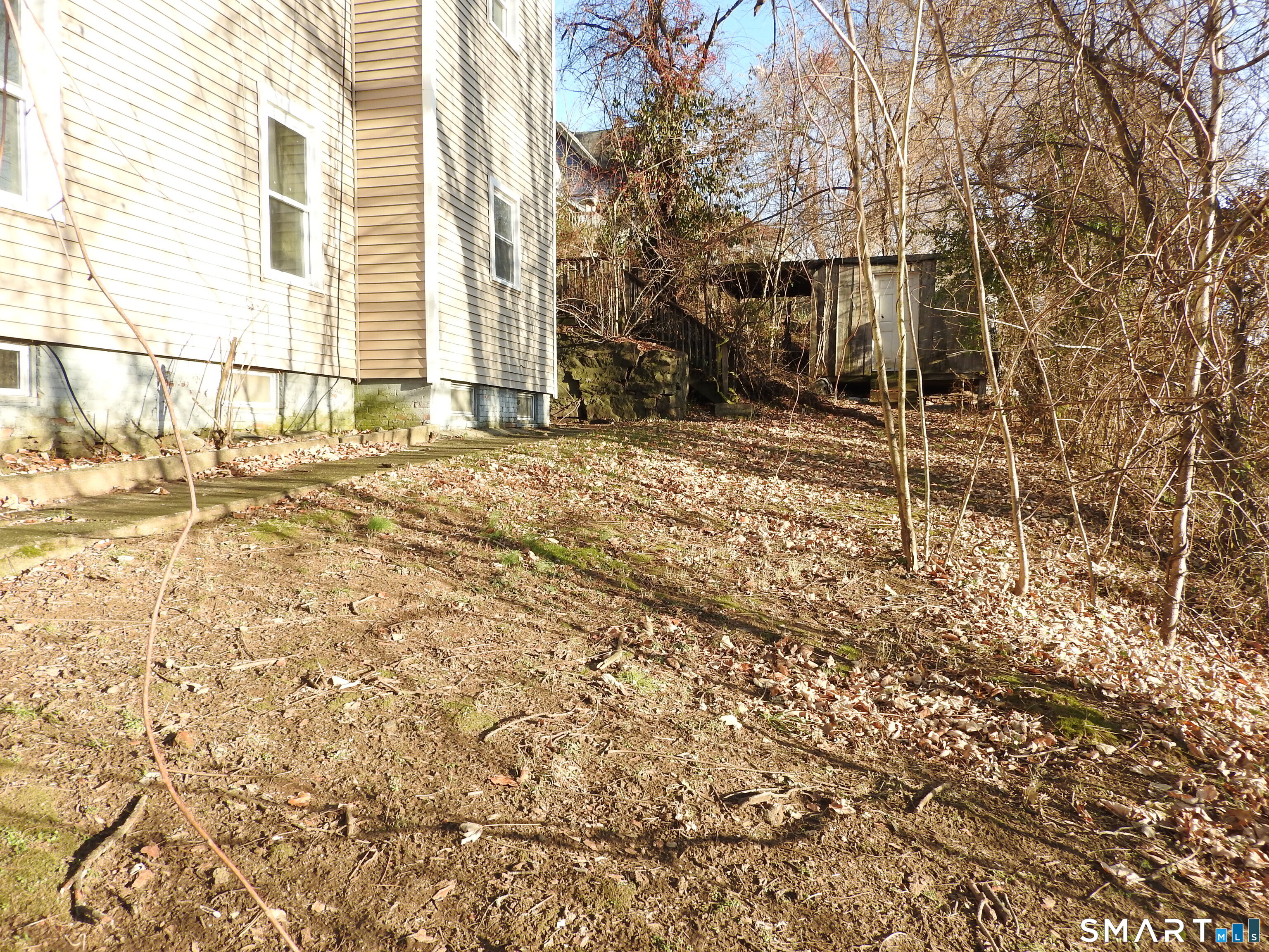 11 Division Street Norwich, CT 06360 - Photo 3 of 10 a backyard of a house with table and chairs