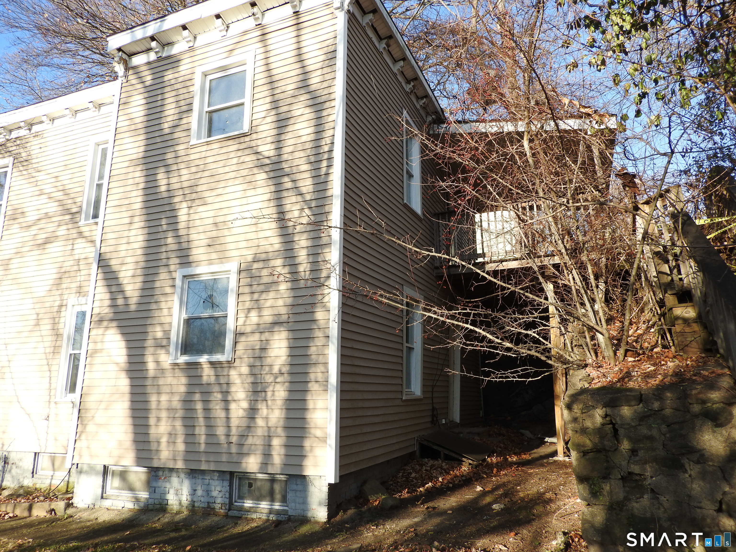 11 Division Street Norwich, CT 06360 - Photo 4 of 10 a view of a wooden house with a tree