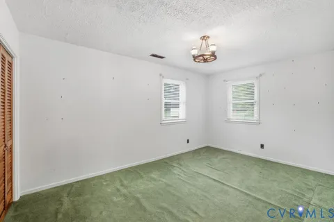 an empty room with a space and windows