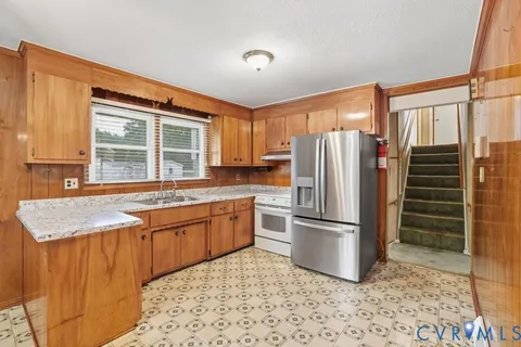 a kitchen with granite countertop a sink and a window