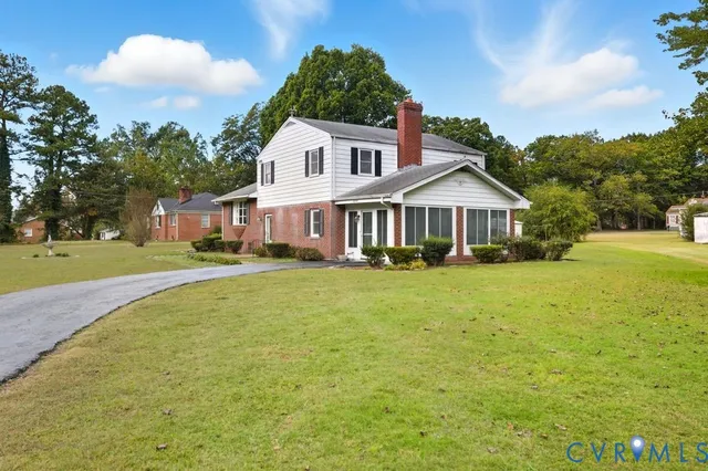a front view of house with yard and green space