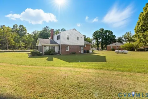 a view of a house with a backyard