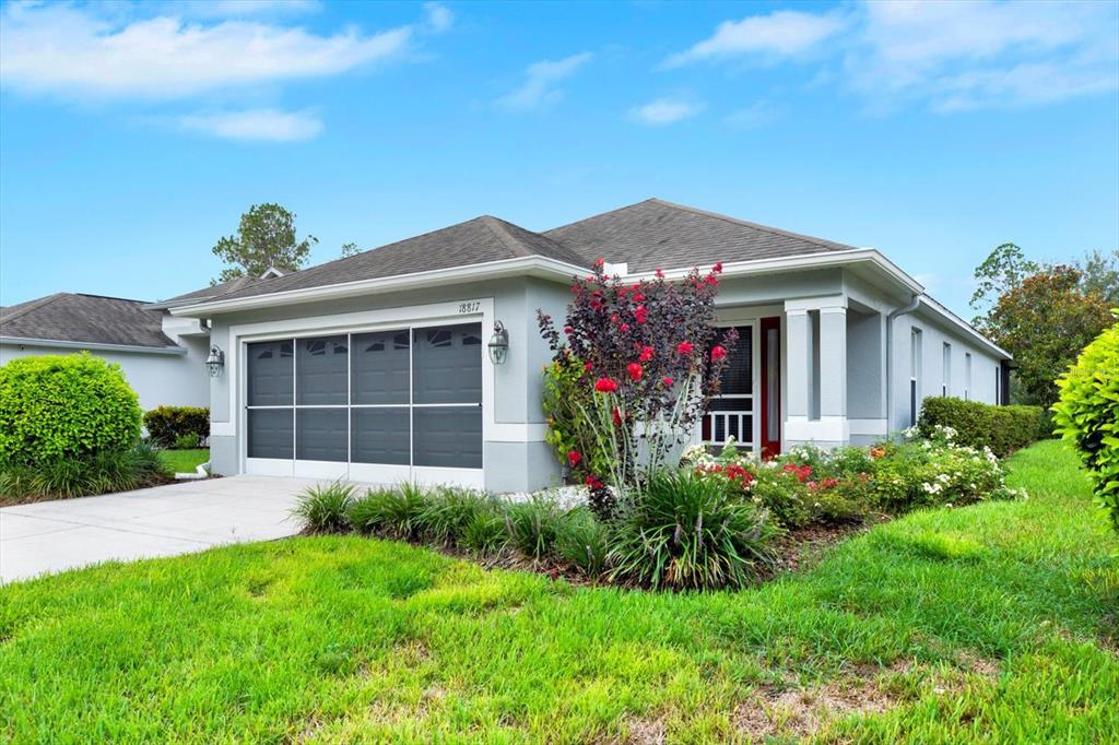 a front view of a house with a garden