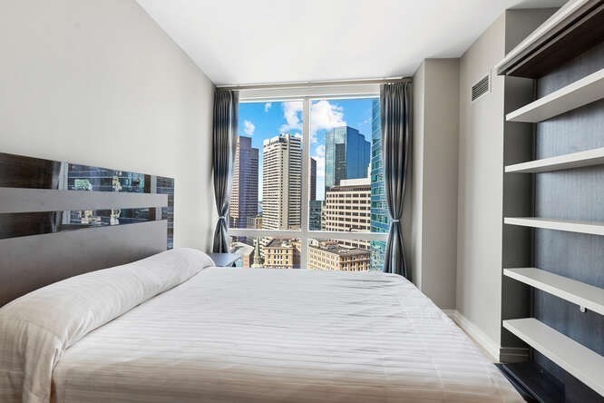 1 Franklin Street, Unit 2307 Boston, MA 02110 - Photo 23 of 28 a bedroom with a large bed and a window
