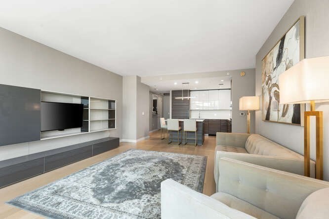 1 Franklin Street, Unit 2307 Boston, MA 02110 - Photo 6 of 28 a living room with furniture and a flat screen tv