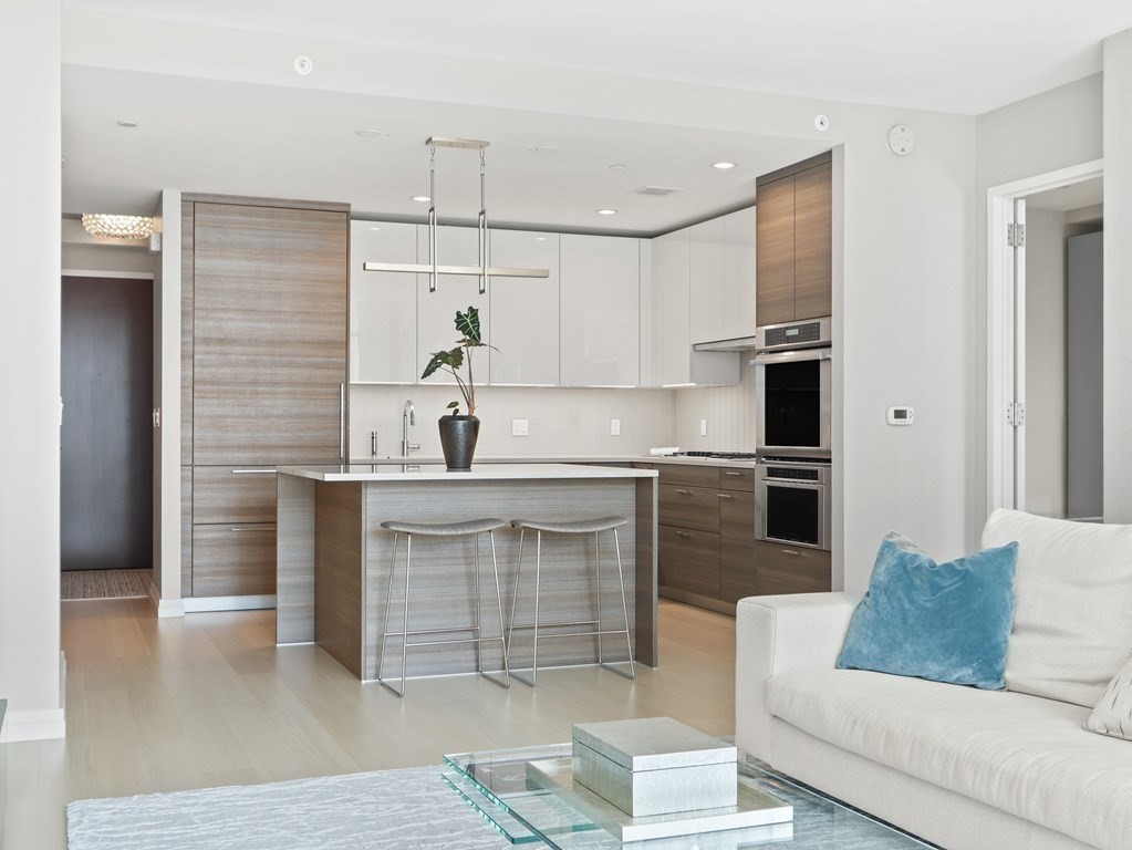 1 Franklin Street, Unit 2307 Boston, MA 02110 - Photo 7 of 28 a kitchen with cabinets and stainless steel appliances