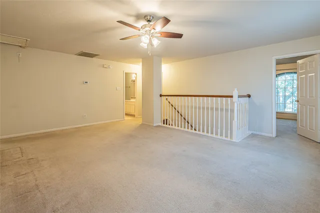 a view of a livingroom with a ceiling fan and window