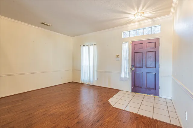 a view of an empty room and wooden floor