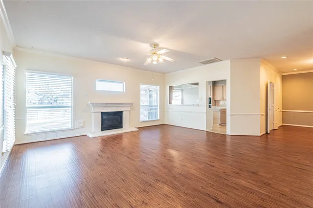 a view of empty room with wooden floor and fireplace
