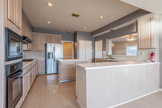 a kitchen with stainless steel appliances a sink and a refrigerator