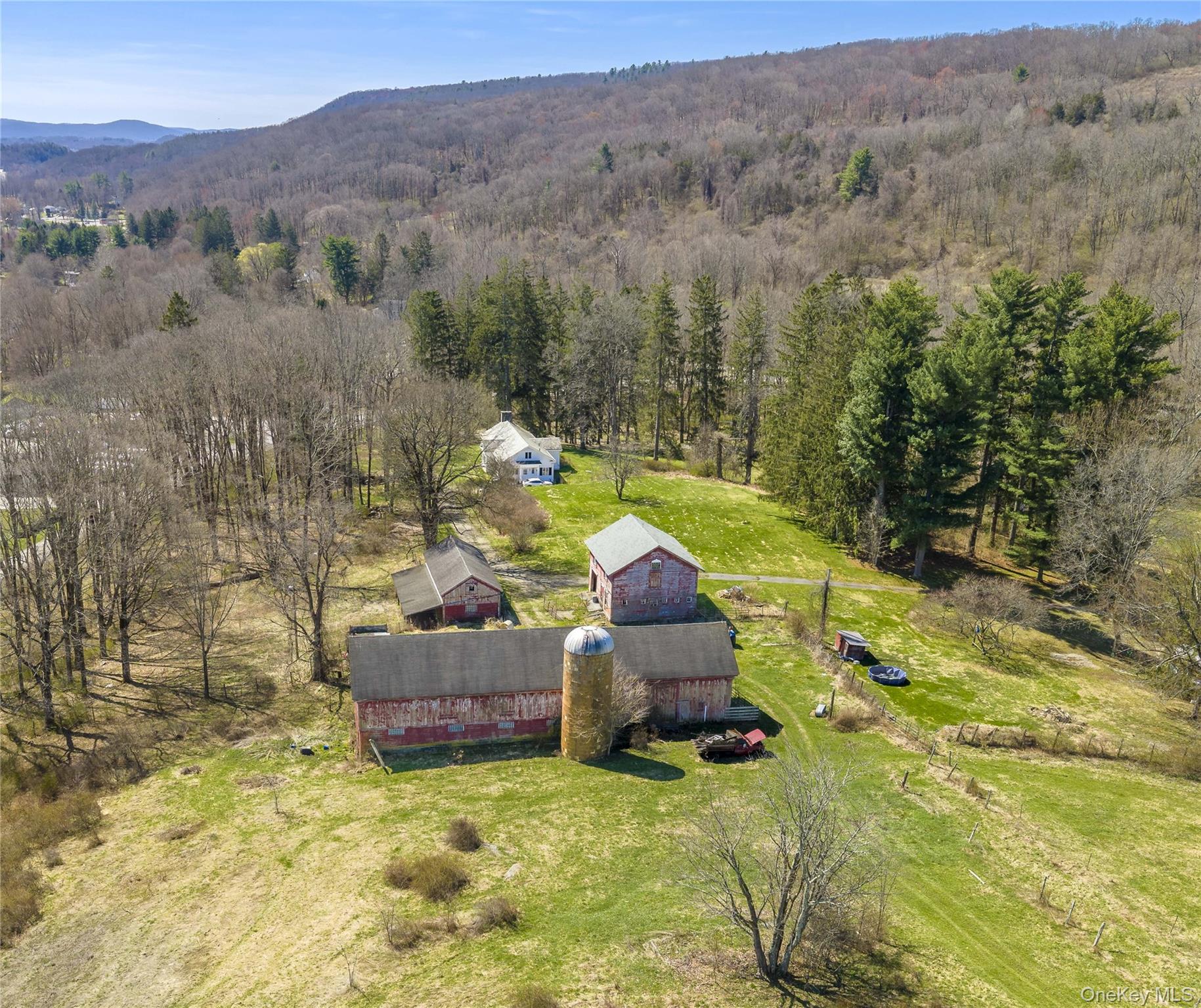 21-23 Tinker Town Road Dover Plains, NY 12522 - Photo 18 of 26 Outbuildings include: A two-story cow barn built in 1920 with 3,800 SF, a 480 SF barn dating to 1950, a detached one-car garage built in 1940 offering 1,056 SF, and additional storage sheds.