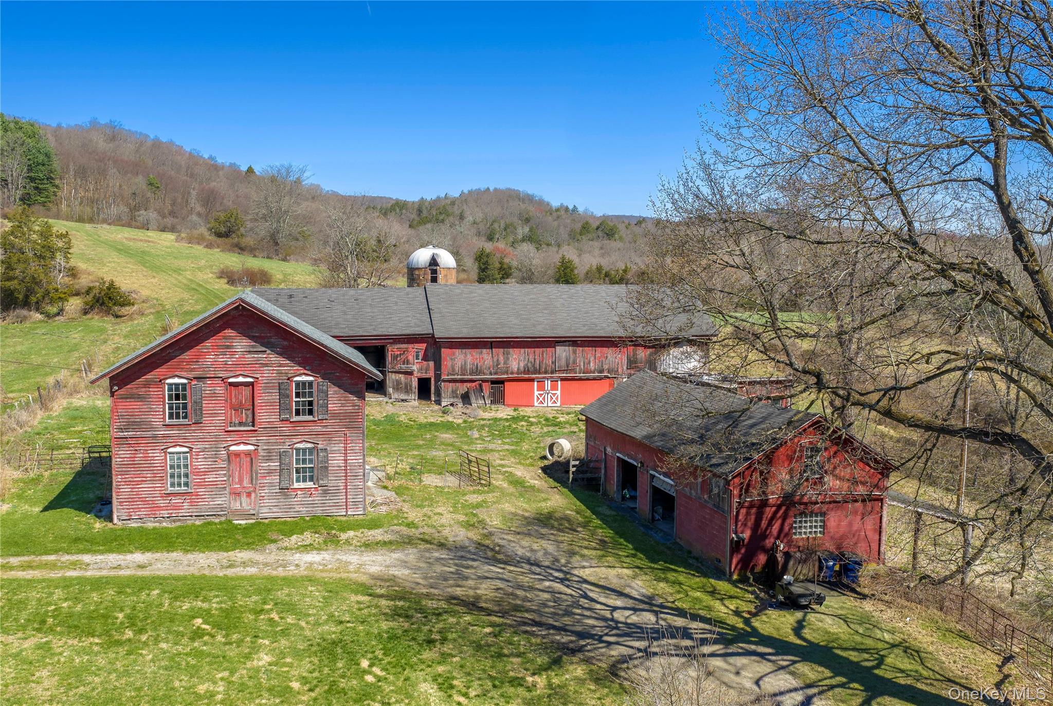 21-23 Tinker Town Road Dover Plains, NY 12522 - Photo 3 of 26 Iconic red barns and silo that define the property’s rural character.