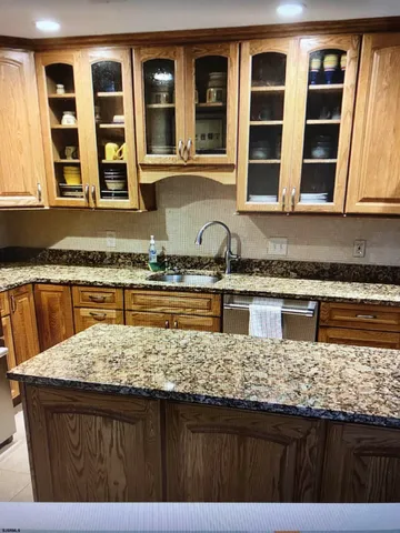 a kitchen with granite countertop a sink and a counter top space