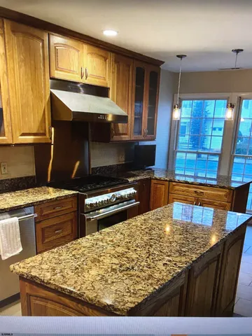 a kitchen with a stove a sink and a microwave