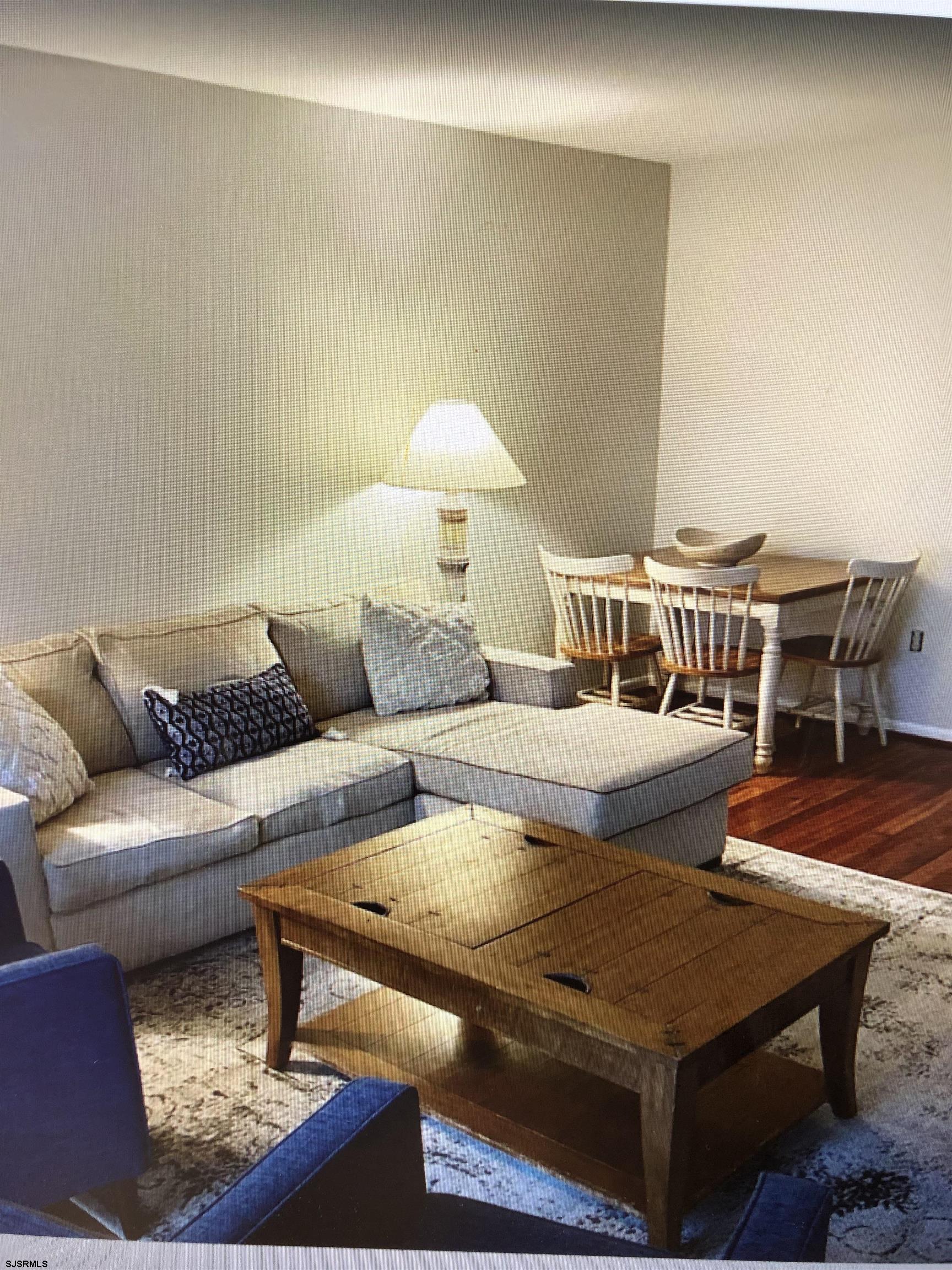 217 3rd Street South, Unit A Brigantine, NJ 08203 - Photo 4 of 10 a living room with furniture and a table