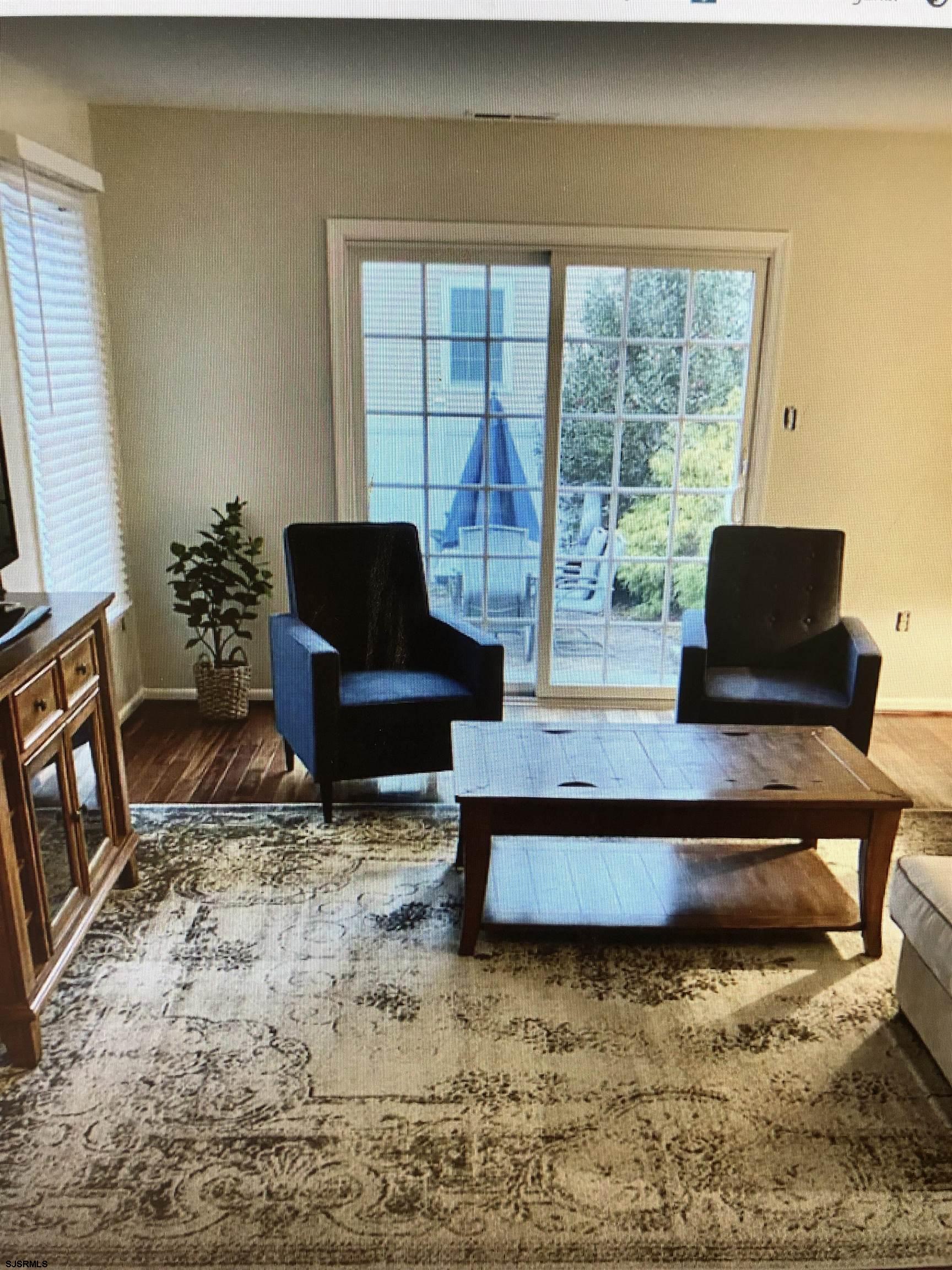 217 3rd Street South, Unit A Brigantine, NJ 08203 - Photo 6 of 10 a living room with furniture and a flat screen tv