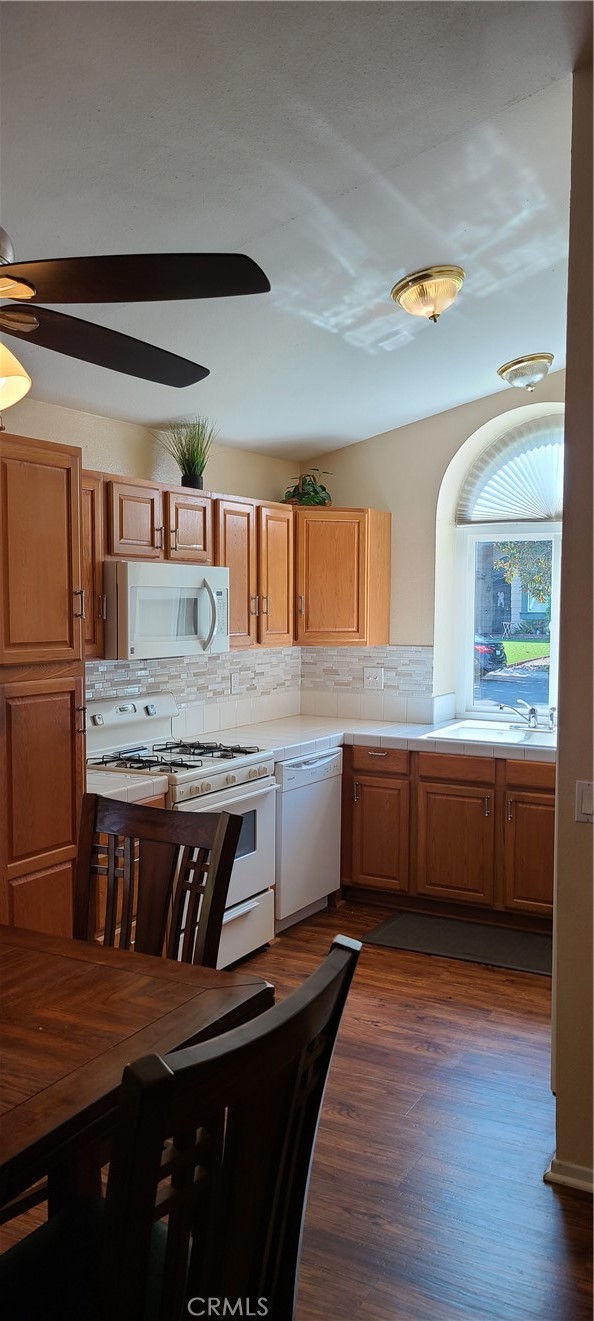 7153 Walcott Place Rancho Cucamonga, CA 91739 - Photo 7 of 35 a kitchen with stainless steel appliances wooden cabinets a sink and a stove