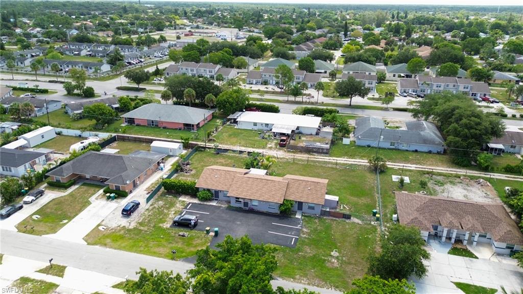 1940 48th Street Southwest Naples, FL 34116 - Photo 13 of 33 Aerial perspective showcasing multiple residential structures and surrounding green spaces