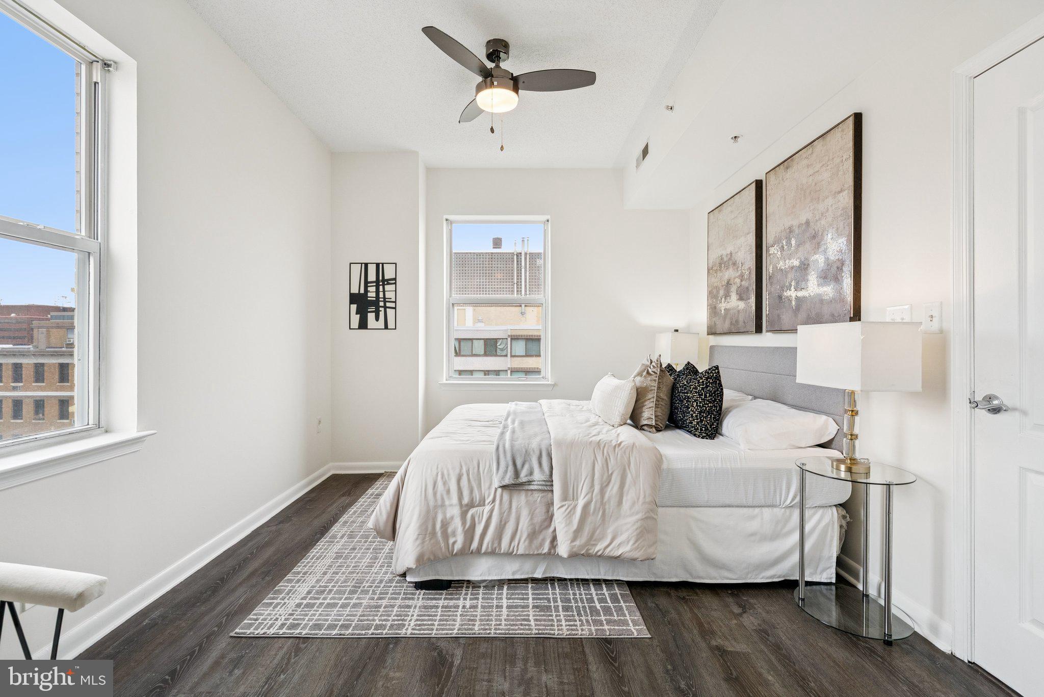 1111 11th Street Northwest, Unit 901 Washington, DC 20001 - Photo 13 of 24 a bedroom with a bed and wooden floor