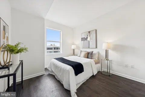 a bed room with a bed and a potted plant