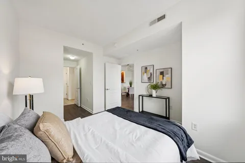 a bedroom with a bed and a lamp