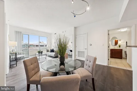 a dining room with furniture and wooden floor