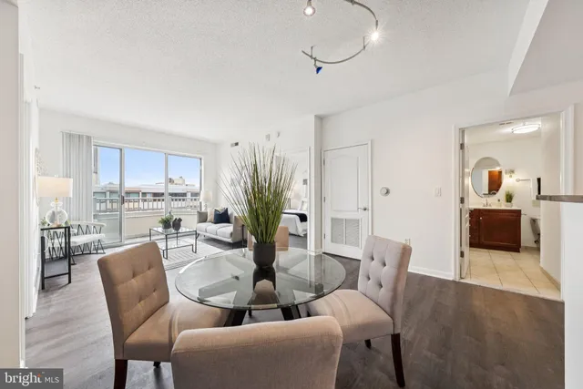 a dining room with furniture and wooden floor